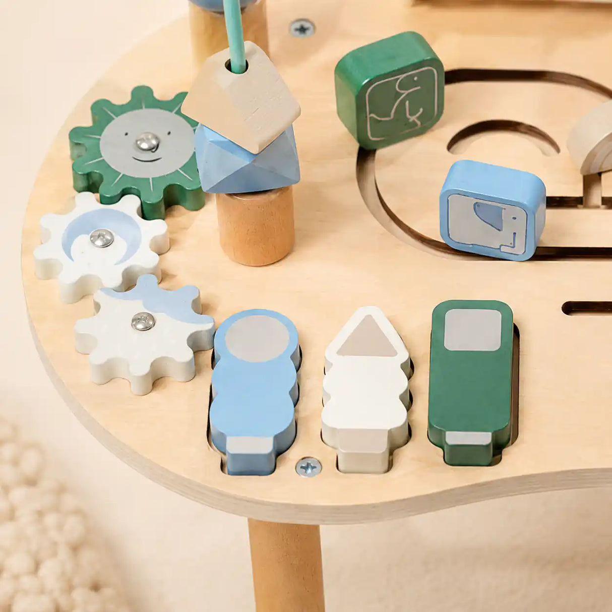 Detail of wooden activity table bead maze with colorful sliding beads on curved wire tracks