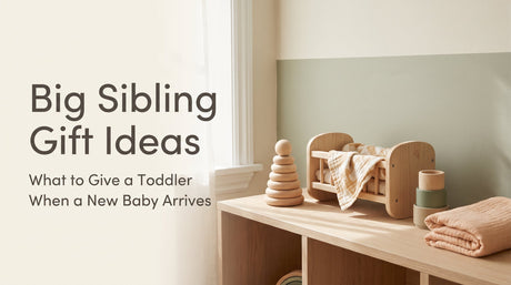 Warm Montessori-style flat lay of wooden toddler toys and a doll cradle, cover image for a big sibling gift ideas guide