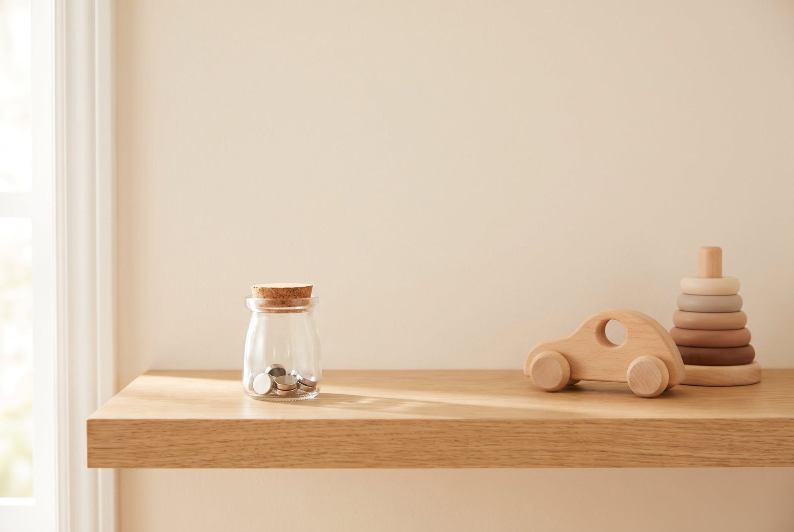 Small high-powered magnets sealed inside a closed jar kept out of a child’s reach, illustrating safe magnet storage