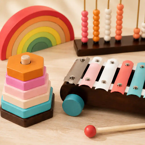 Toddler sliding wooden beads across the golden arches of the Montessori counting abacus during supervised play