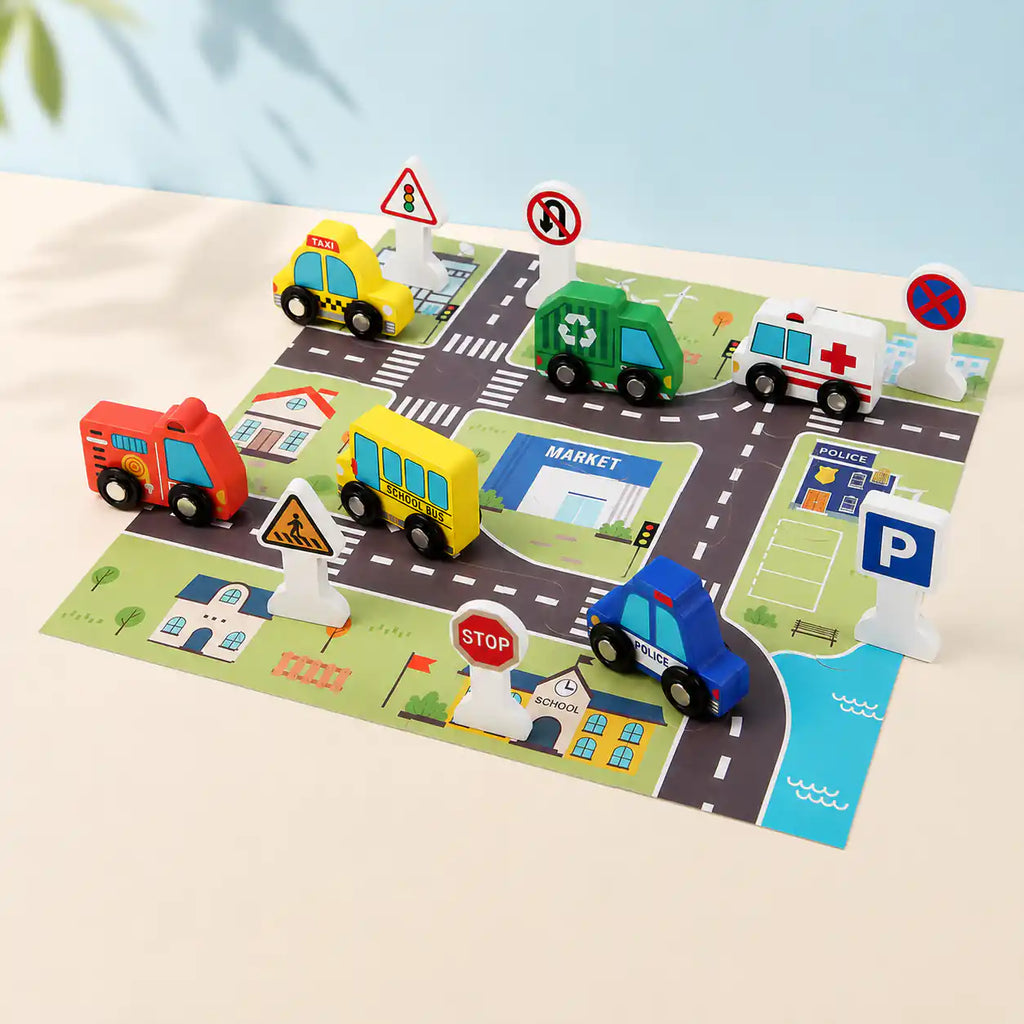 Young child playing with the wooden city traffic play set at a wooden table, arranging vehicles on the printed road map