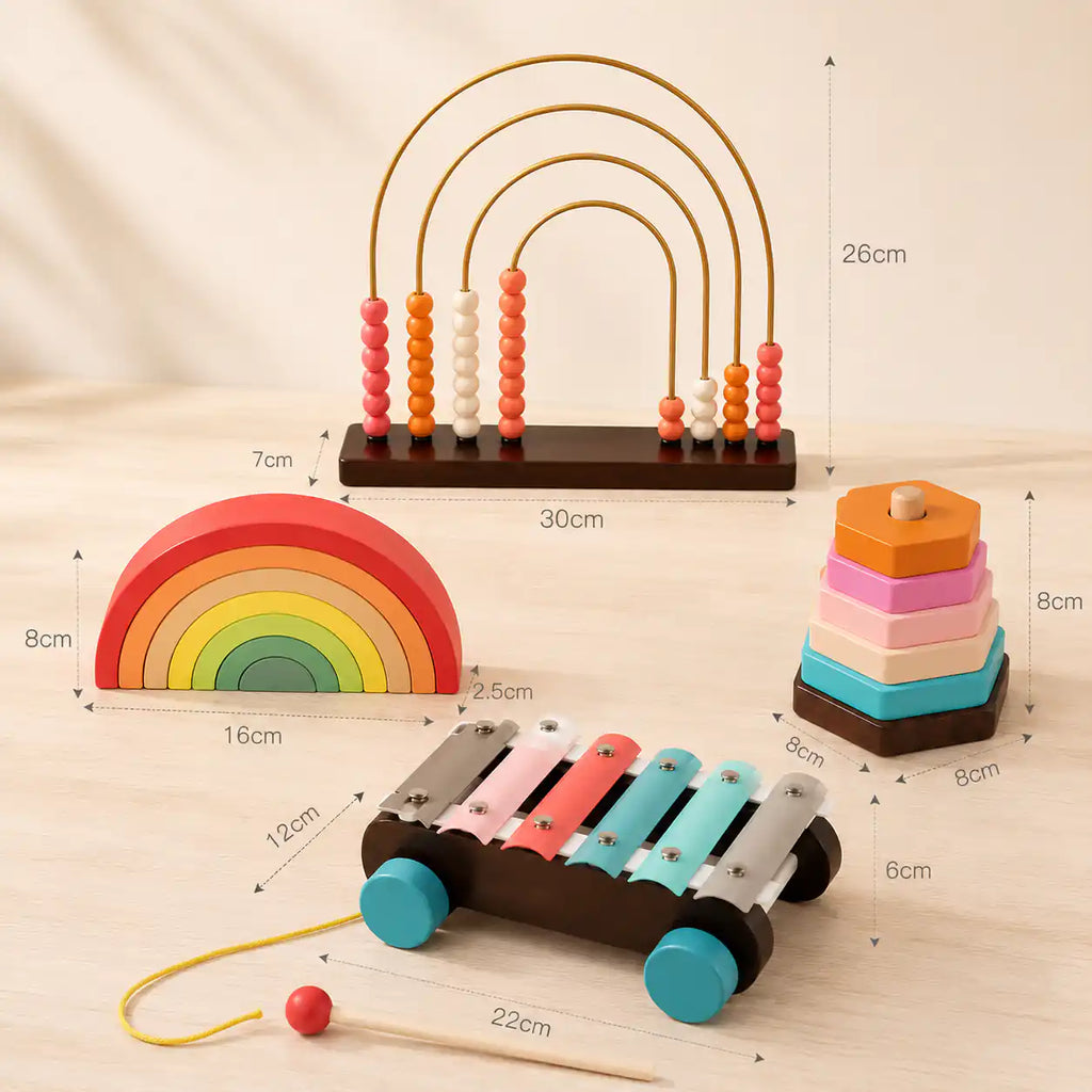 Toddler tapping the colorful metal bars of the wooden pull-along xylophone with all 4 bundle toys nearby