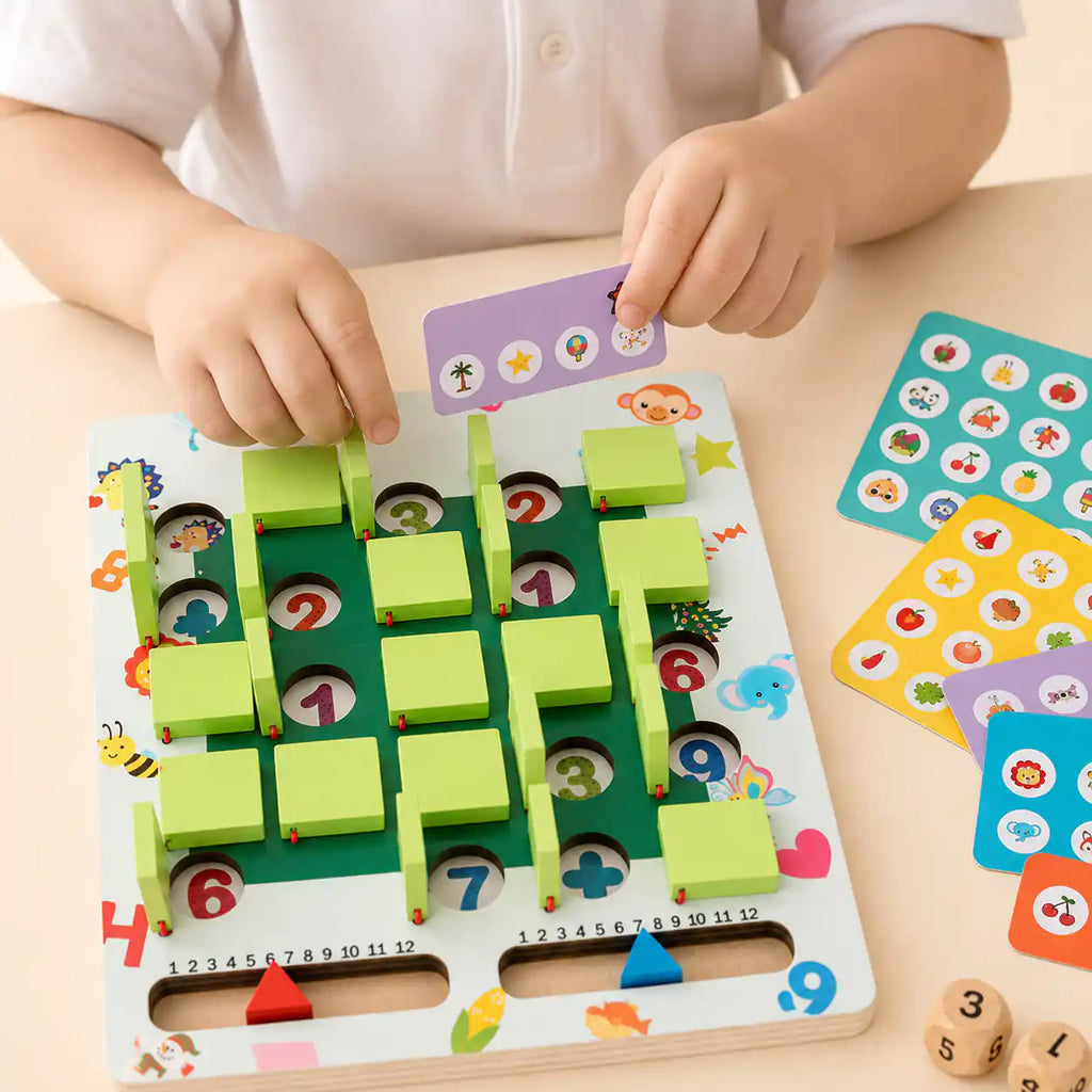 Child holding a purple picture card above the wooden memory game board, with additional picture cards spread out to the side