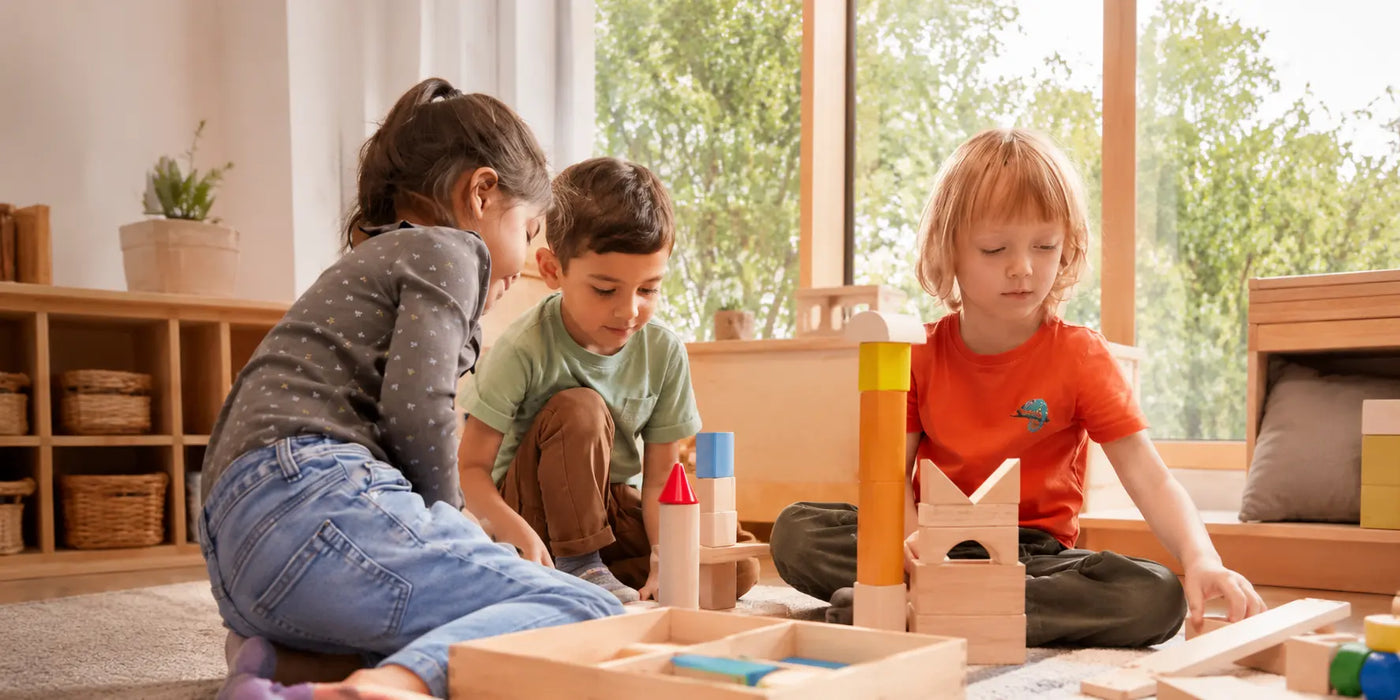 Children stacking colorful wooden toys together on a cozy rug — JuniSprouts Montessori stacking toys that support fine motor skills and focus
