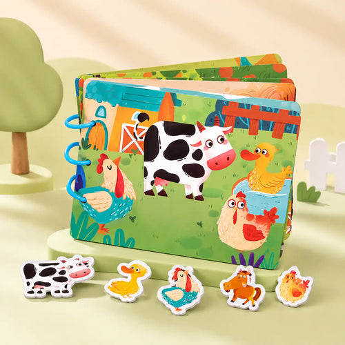 Open Montessori busy book showing a colorful activity page with interactive felt and wooden pieces
