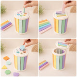 Pastel wooden multi-sorter cylinder with shapes, dowels, and sticks displayed in a flat lay on warm neutral background