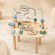 Wooden 10-in-1 Montessori activity table with bead maze, spinning gears, ABC blocks, mini abacus, and animal sliders on cream background