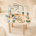 Wooden 10-in-1 Montessori activity table with bead maze, spinning gears, ABC blocks, mini abacus, and animal sliders on cream background
