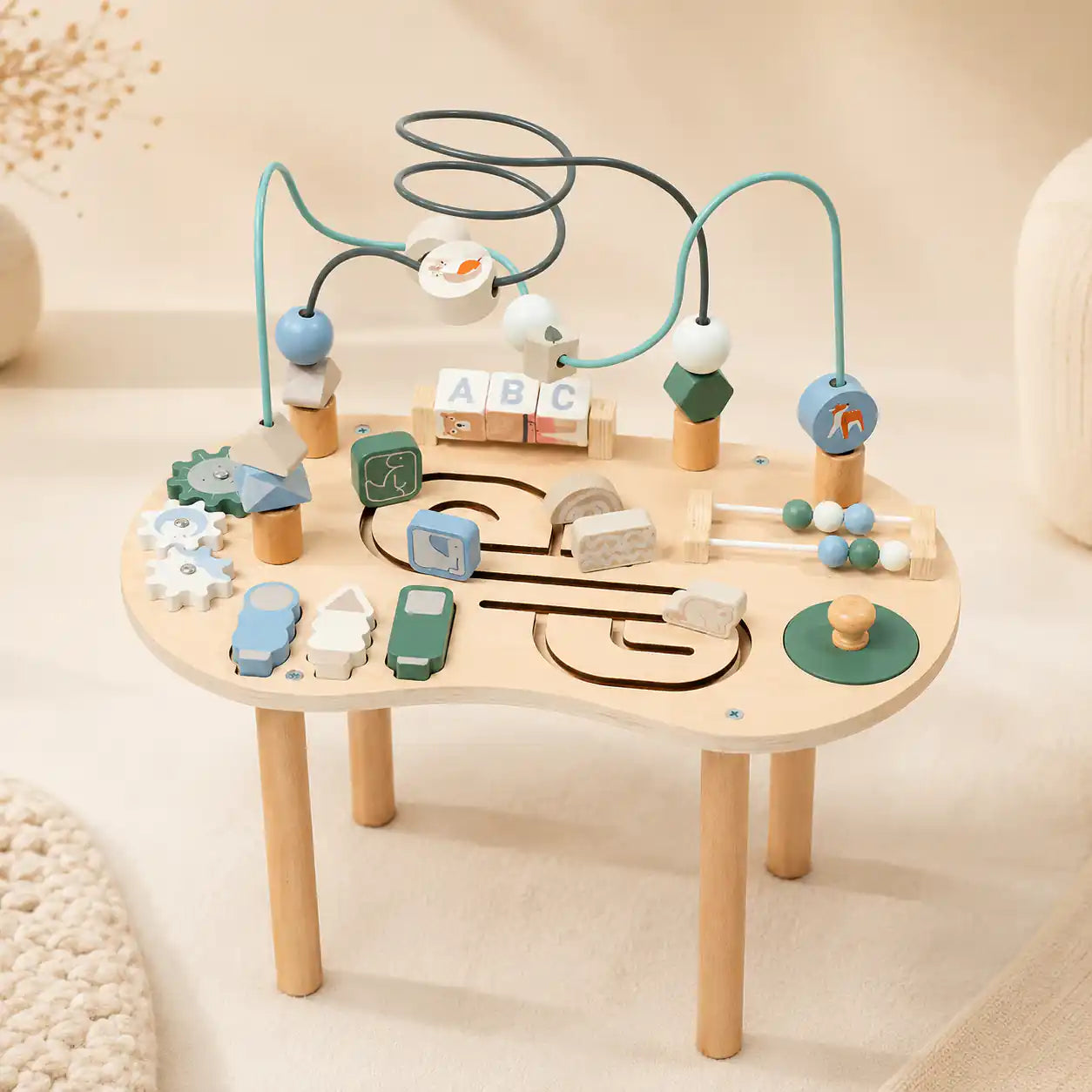 Wooden 10-in-1 Montessori activity table with bead maze, spinning gears, ABC blocks, mini abacus, and animal sliders on cream background