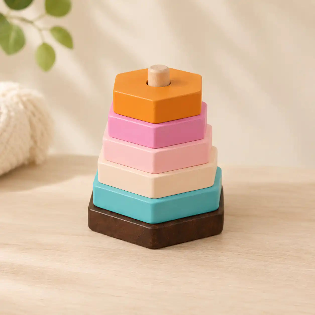 Close-up of the wooden 4-in-1 learning bundle showing the rainbow puzzle, abacus, xylophone, and hexagon stacker