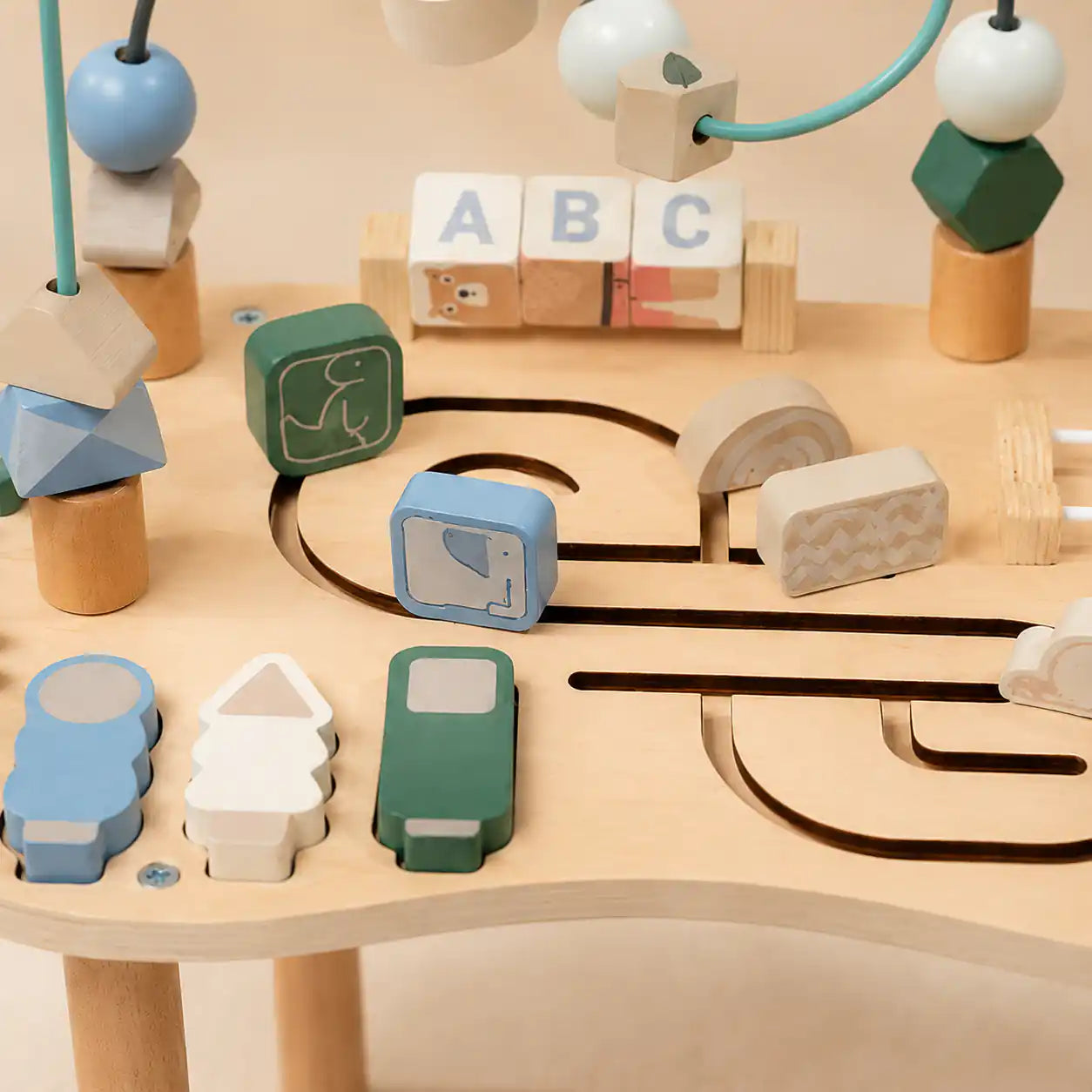 Wooden Montessori table close-up of rotating ABC blocks for early alphabet recognition and fine motor play