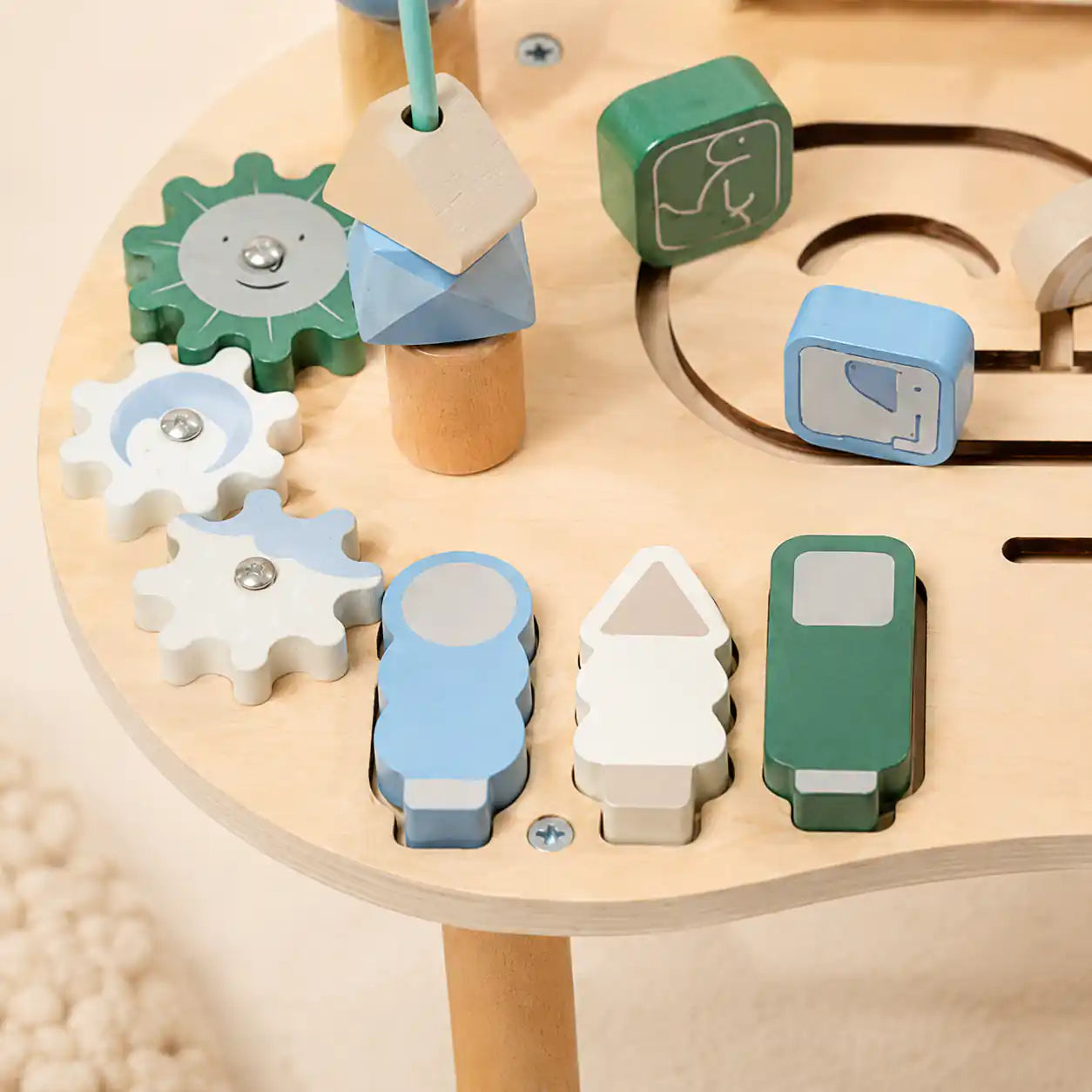 Detail of wooden activity table bead maze with colorful sliding beads on curved wire tracks
