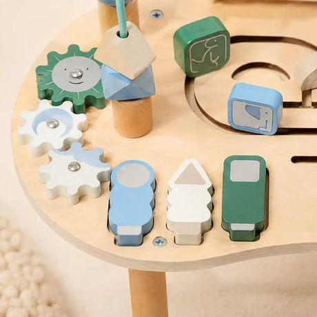 Detail of wooden activity table bead maze with colorful sliding beads on curved wire tracks