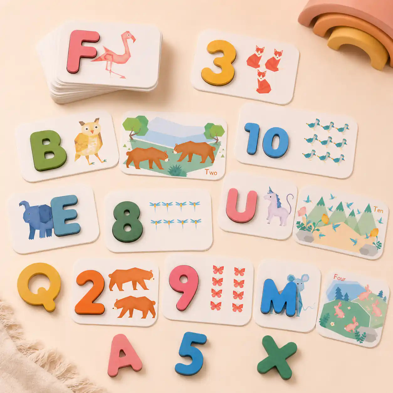 Wooden alphabet and number flashcards spread out for Montessori matching play