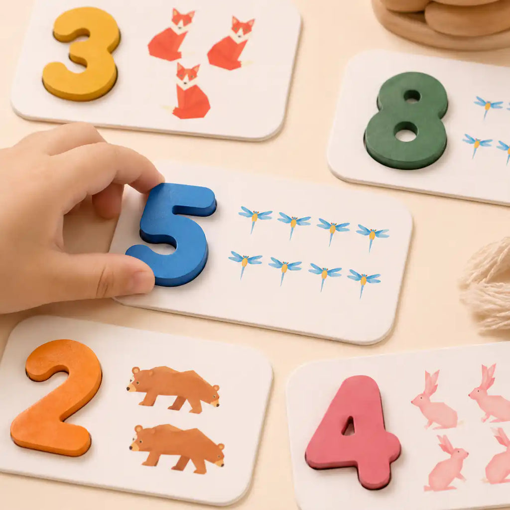 Wooden number flashcards with foxes, dragonflies, bears, and rabbits for counting practice