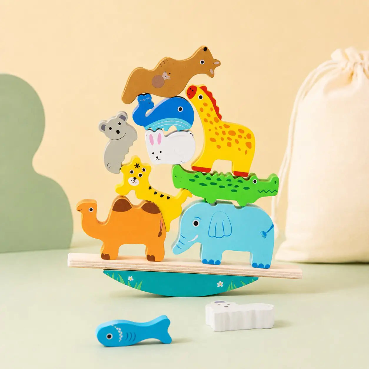 Side view of the wooden animal balancing stacker showing the curved rocking base and nested animals