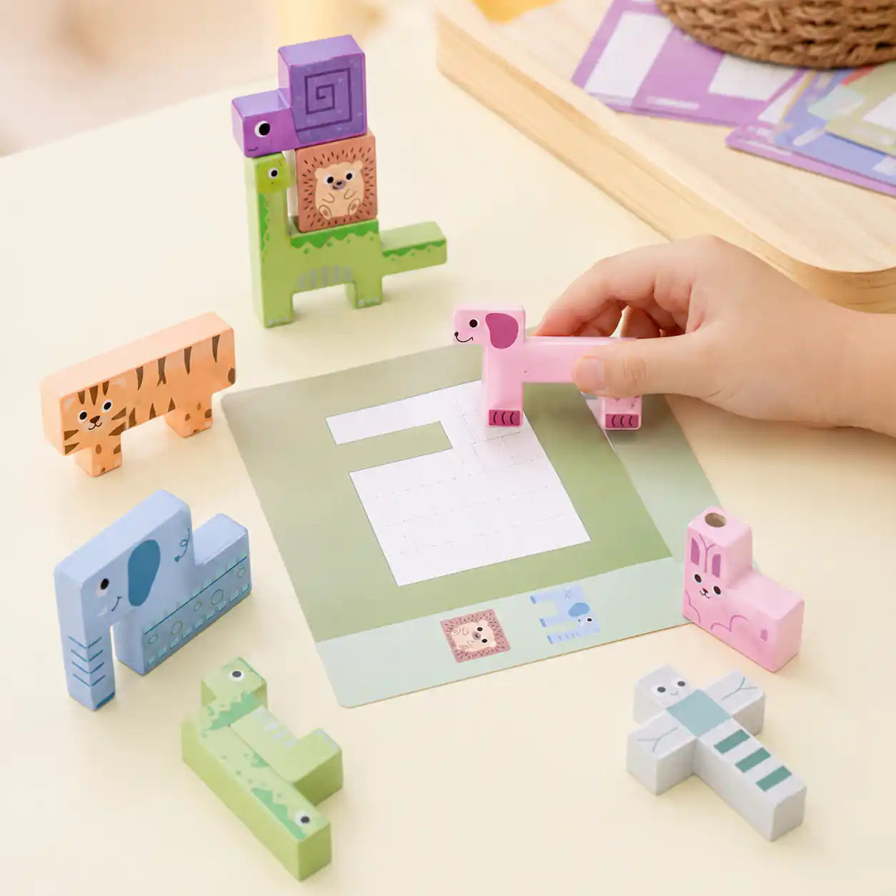 Side angle of wooden animal puzzle stacker showing layered animal silhouettes and painted finish