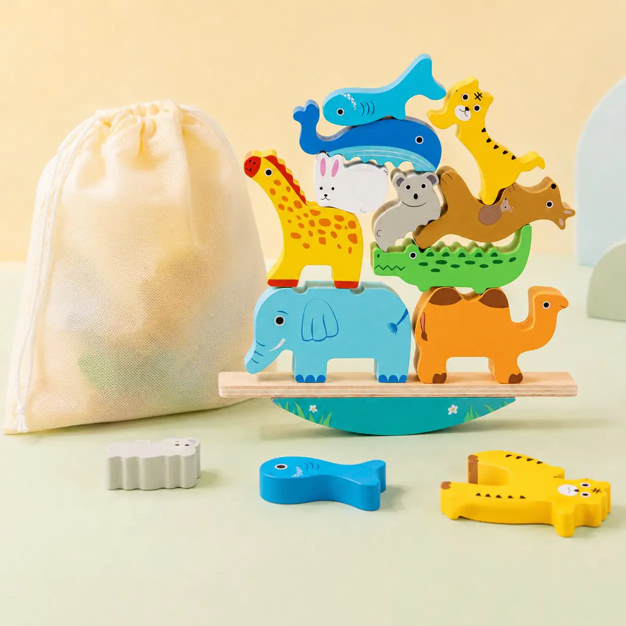 Close-up of the individual wooden animal pieces including giraffe, elephant, whale and tiger