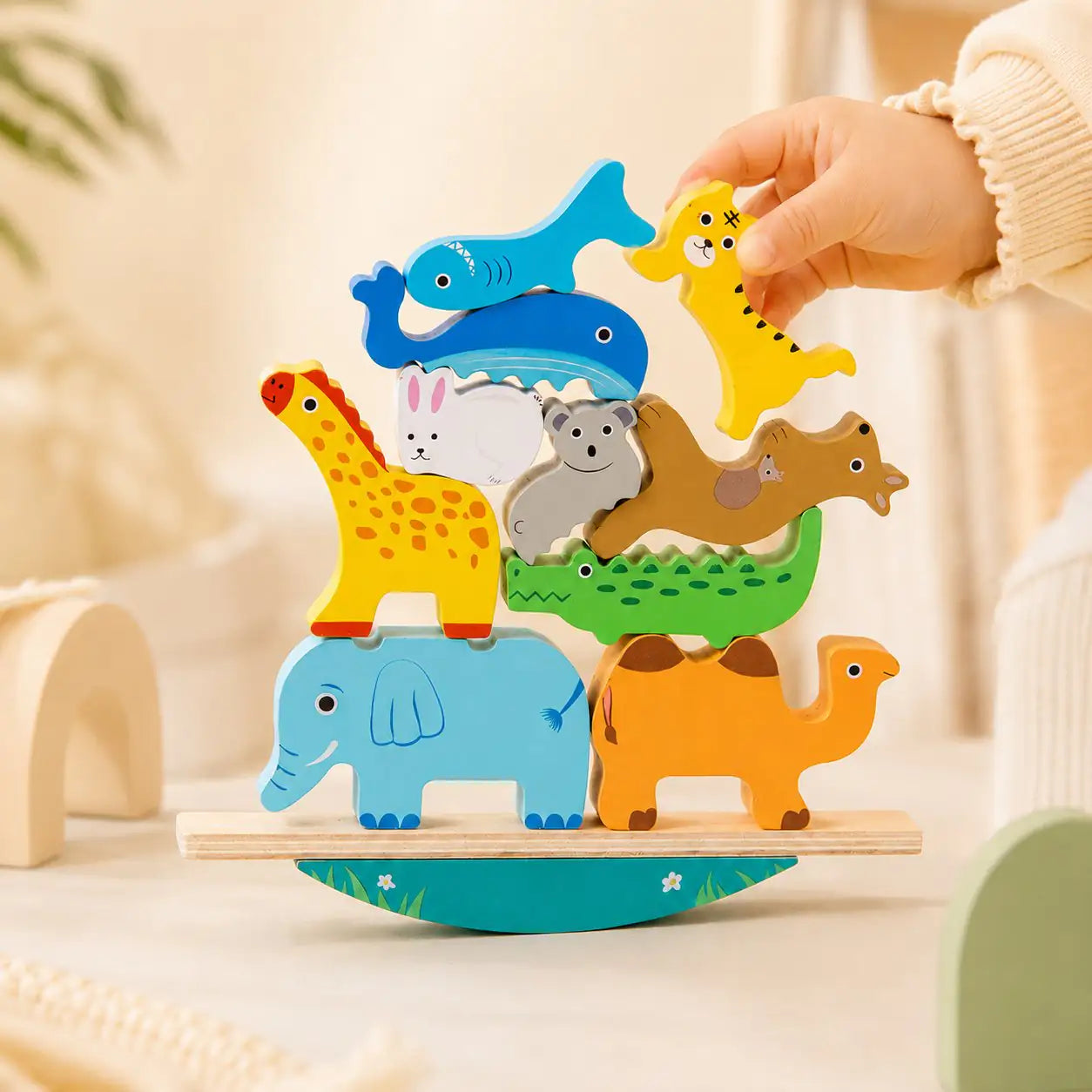 Curved rocking base of the wooden animal balancing stacker for open-ended toddler play