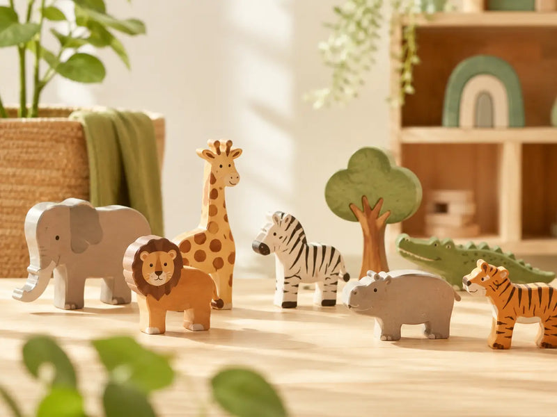 Wooden animal toys grouped together on a warm neutral background — JuniSprouts animal toy collection for imaginative, open-ended toddler play