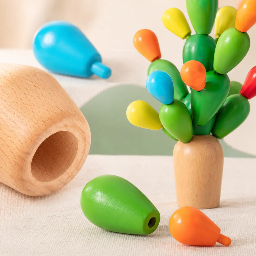 Close-up of the smooth green cactus pieces and natural beech base of the balancing cactus toy