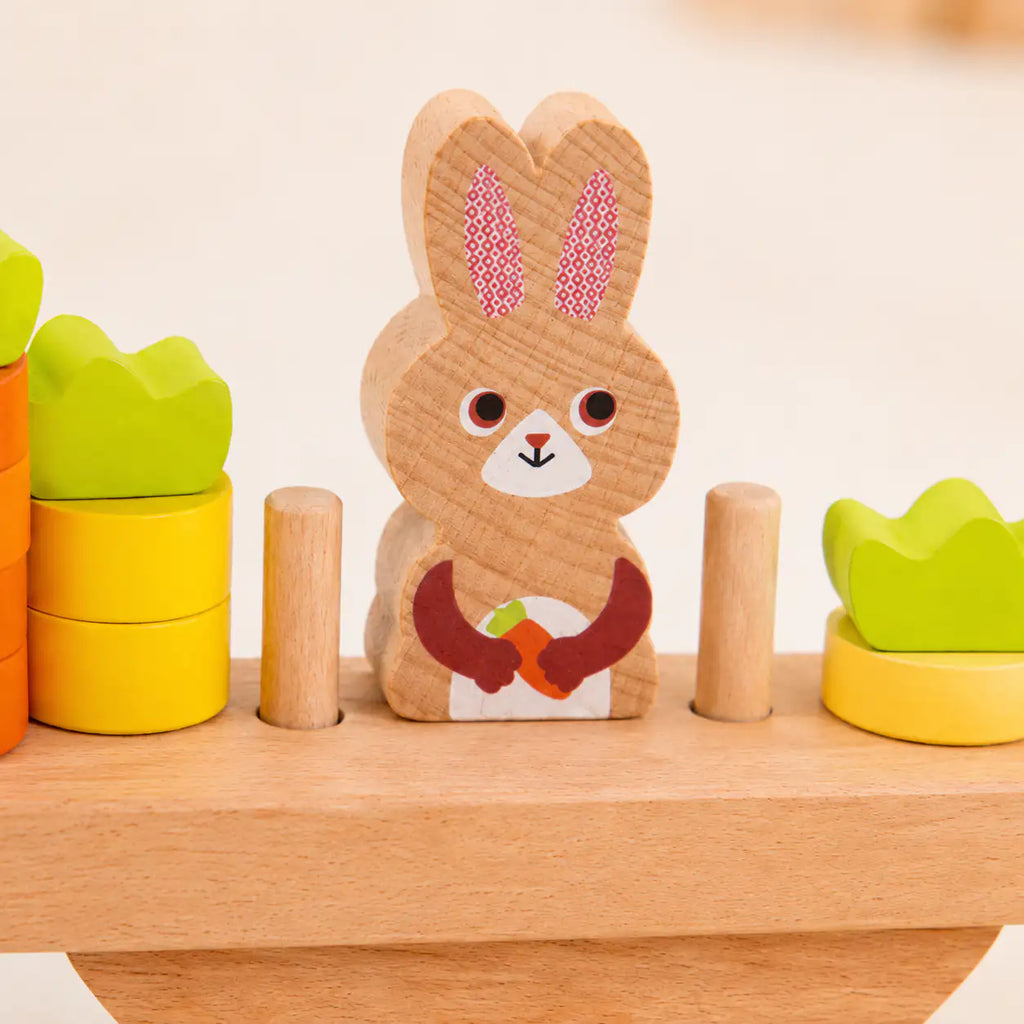 Wooden bunny balance scale styled in a warm Montessori-inspired playroom