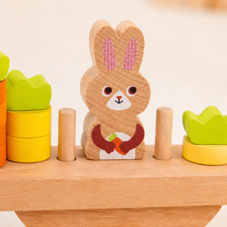 Wooden bunny balance scale styled in a warm Montessori-inspired playroom