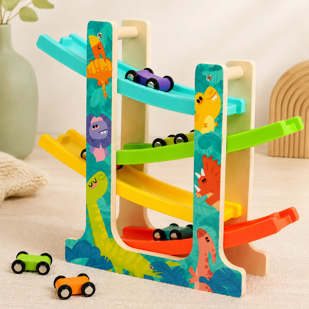 Two mini wooden cars racing side by side down the dinosaur ramp racer tracks