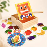 Wooden feed the bear pretend play toy with smiling bear panel, wooden spoon scooping a tomato slice, and assorted wooden food pieces on a cream background