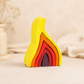 Wooden flame stacking puzzle in yellow, orange, red, and ember tones on a warm cream background, Waldorf-inspired for ages 4+
