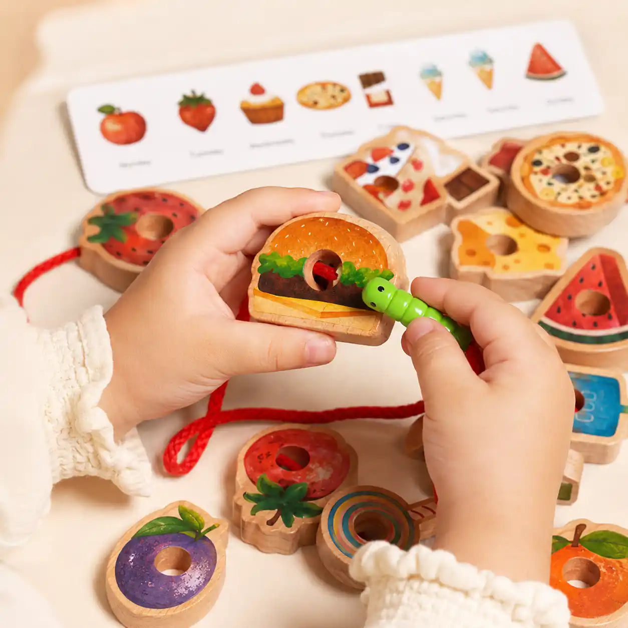 Wooden food lacing set stored neatly in a natural linen drawstring bag