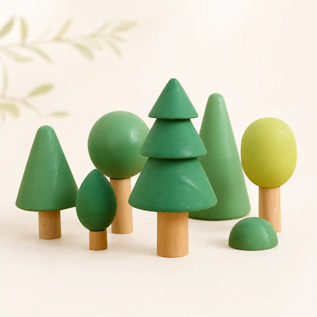Wooden forest tree set clustered together on a soft cream surface, hero shot