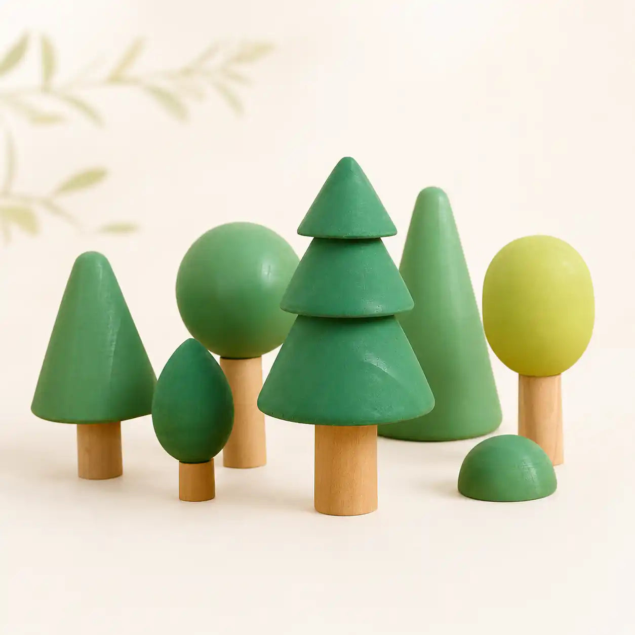 Wooden forest tree set clustered together on a soft cream surface, hero shot