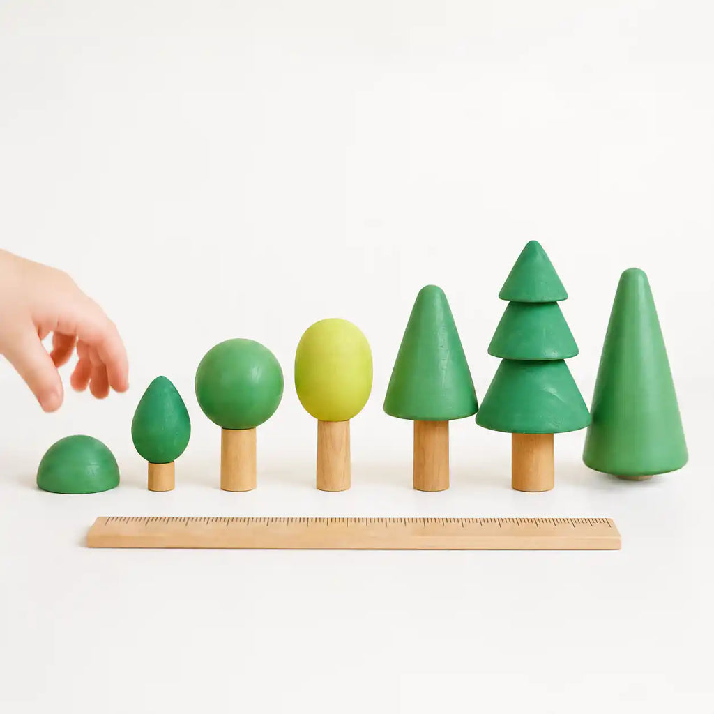 Wooden forest tree set arranged into an imaginative play scene with grouped trees