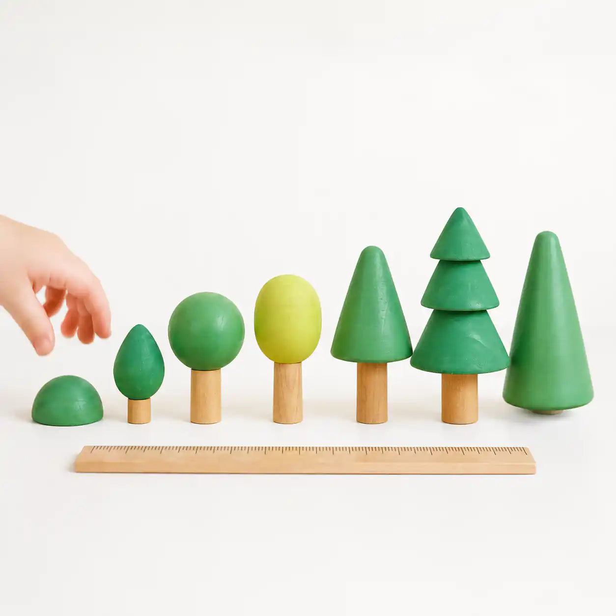 Wooden forest tree set arranged into an imaginative play scene with grouped trees
