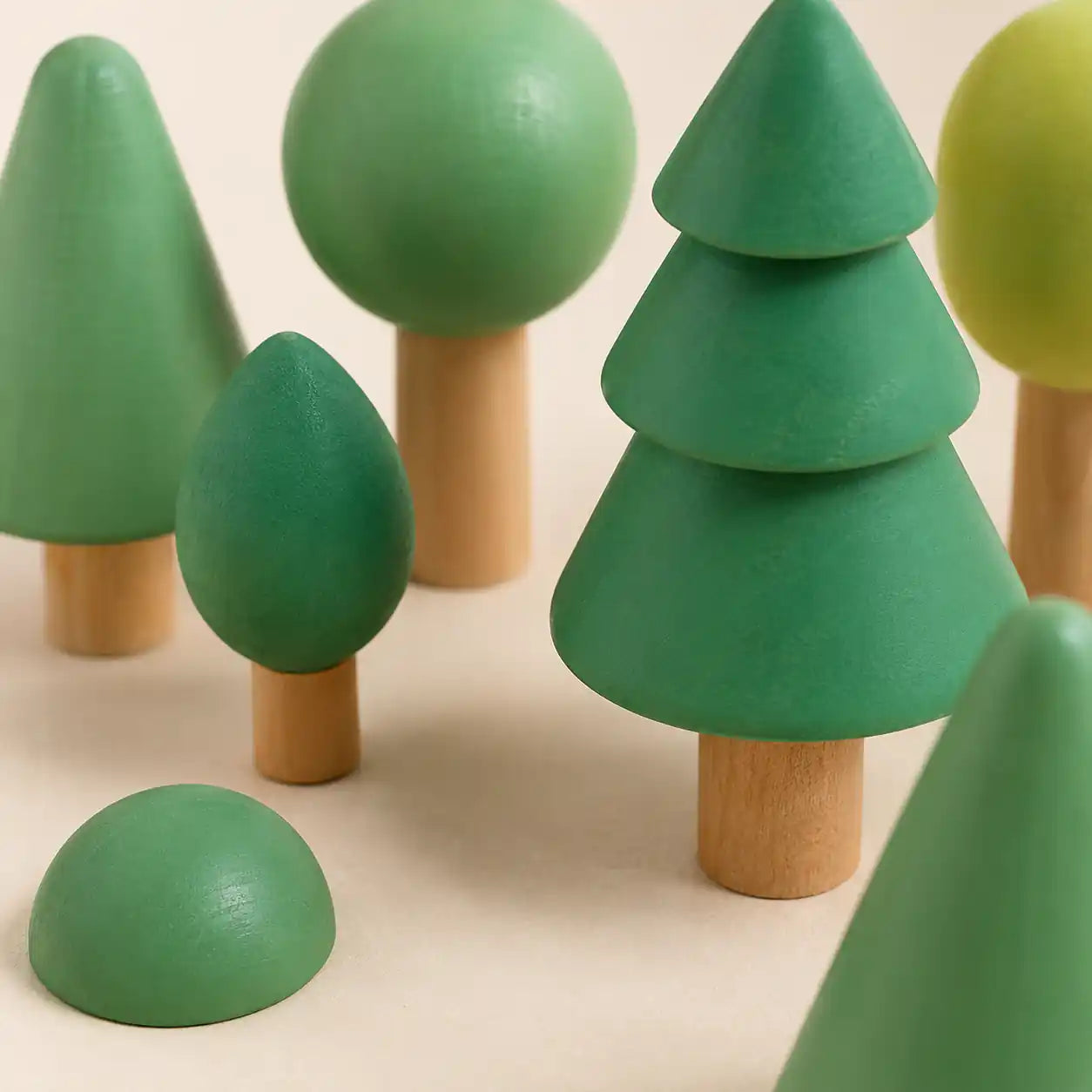 Top-down view of wooden forest tree set arranged into a small forest scene