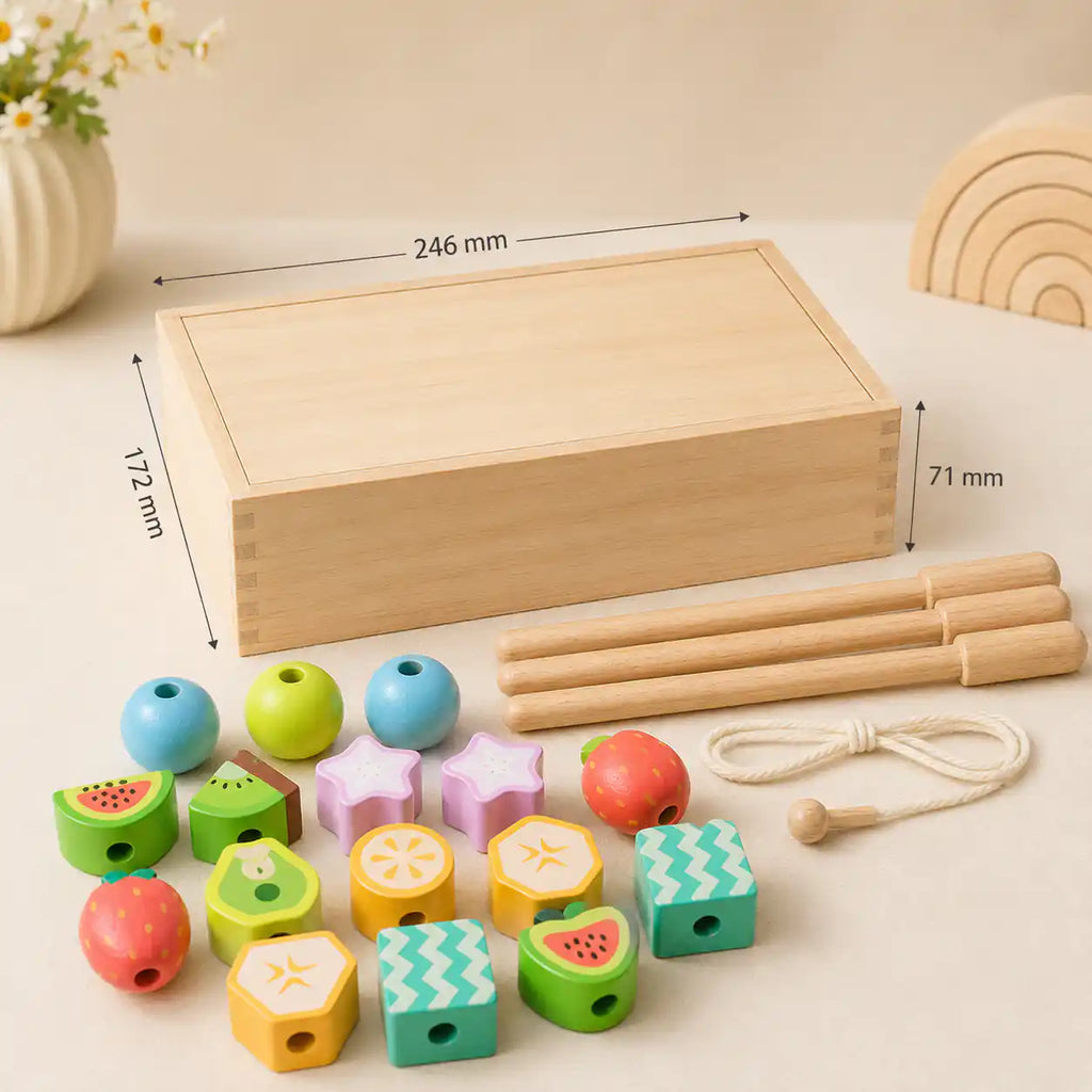 Wooden box dimensions diagram showing 246 mm by 172 mm by 71 mm, with wooden dowels, lacing string, and 25 fruit beads laid out below