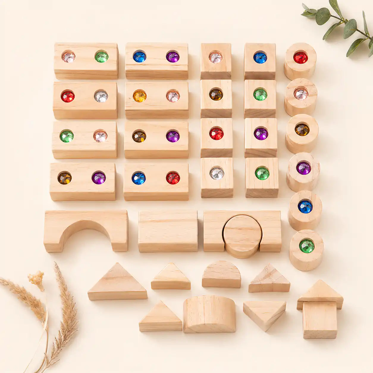 Close-up of faceted gems embedded in wooden building block frames