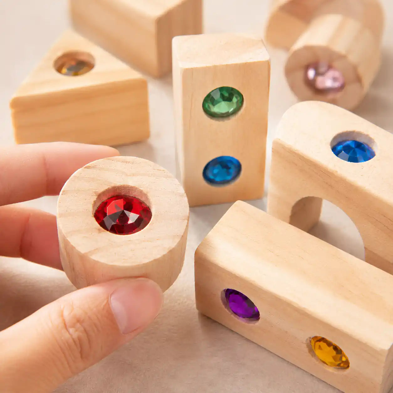 Wooden gem building blocks tidied in their storage tray for shelf display