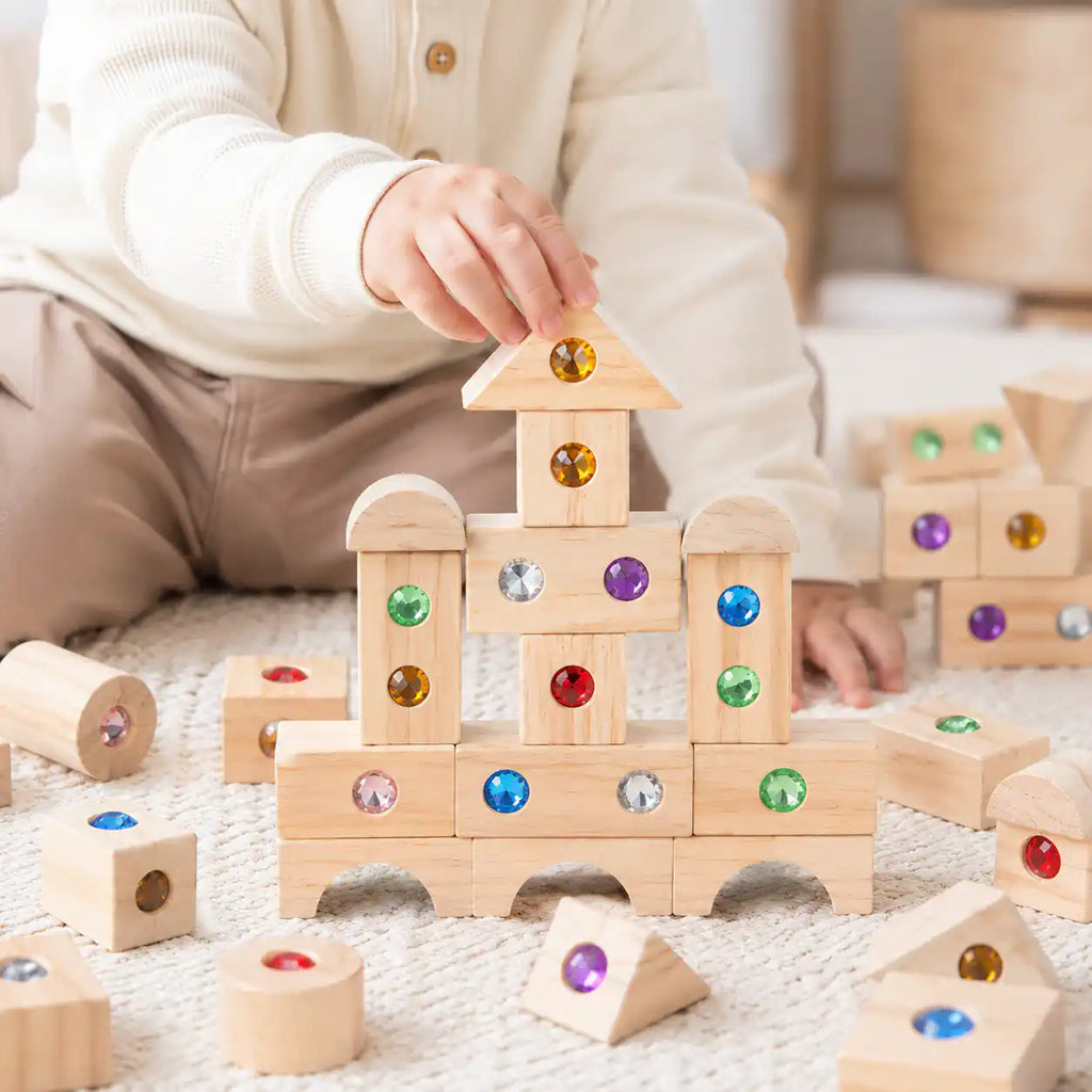 Toddler engaging with the Montessori wooden gem building blocks set