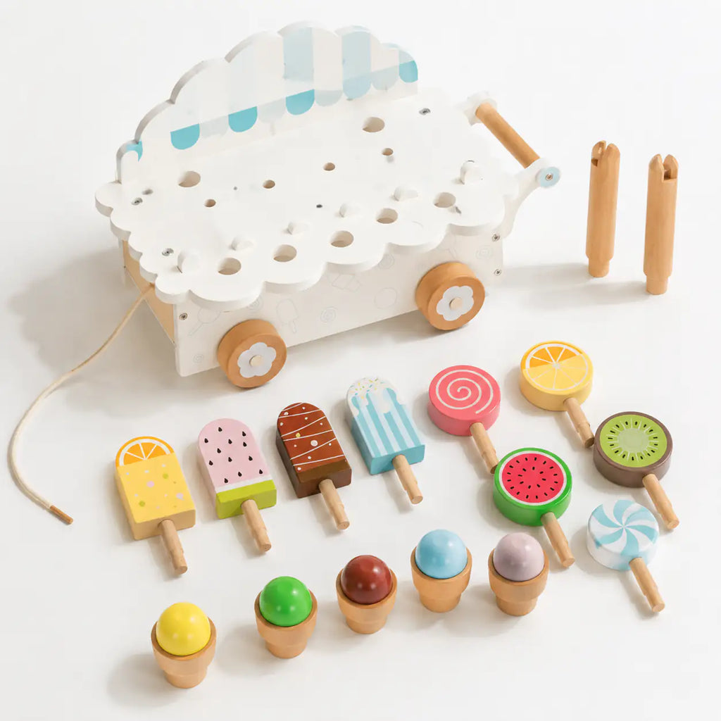 Hidden bottom storage drawer in the wooden ice cream cart with all wooden treat pieces inside