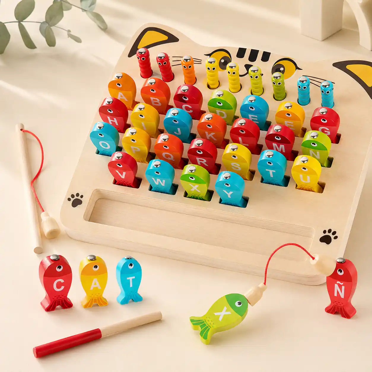 Wooden magnetic alphabet fishing game with the word CAT spelled out during play