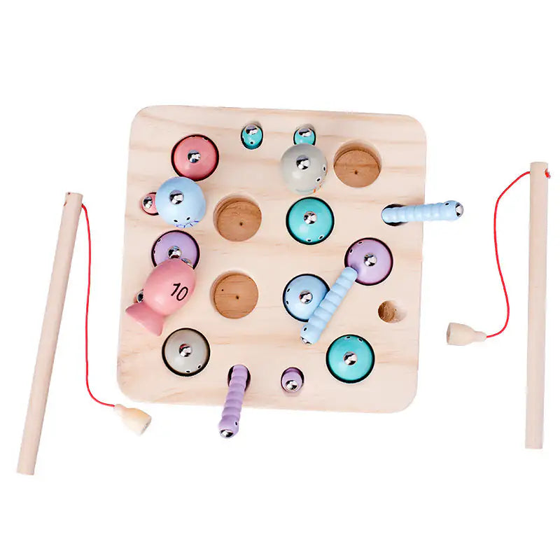 Close-up of the wooden fishing game board with pastel numbered and patterned fish in their holes