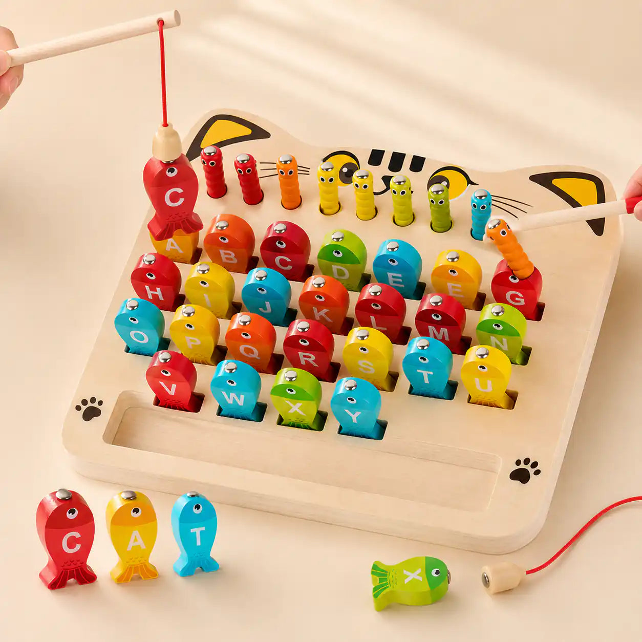 Both magnetic fishing rod and wand in use on the wooden alphabet fishing game