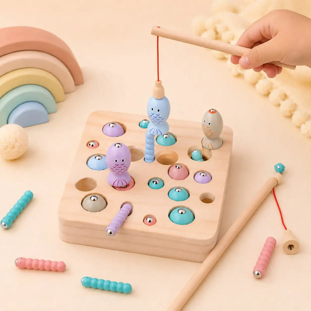 Wooden magnetic fishing rod catching a pastel fish from the natural wood game board