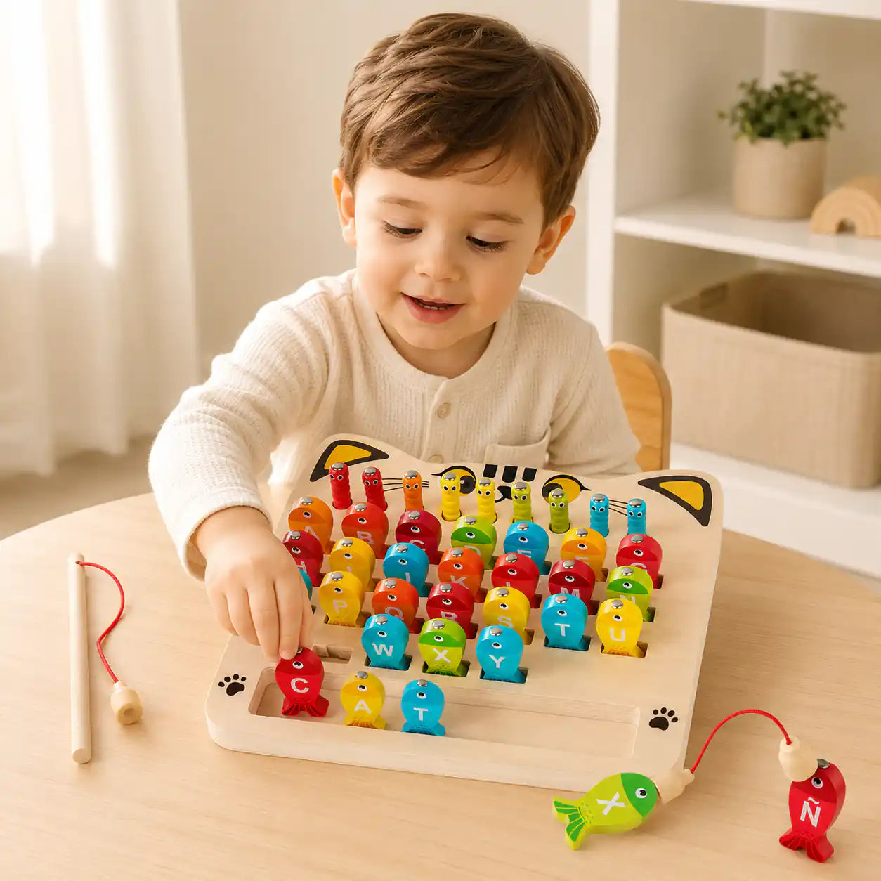 Toddler using the magnetic wand on the wooden alphabet fishing game