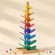 Wooden marble run music tree with rainbow leaf chimes on a cream background