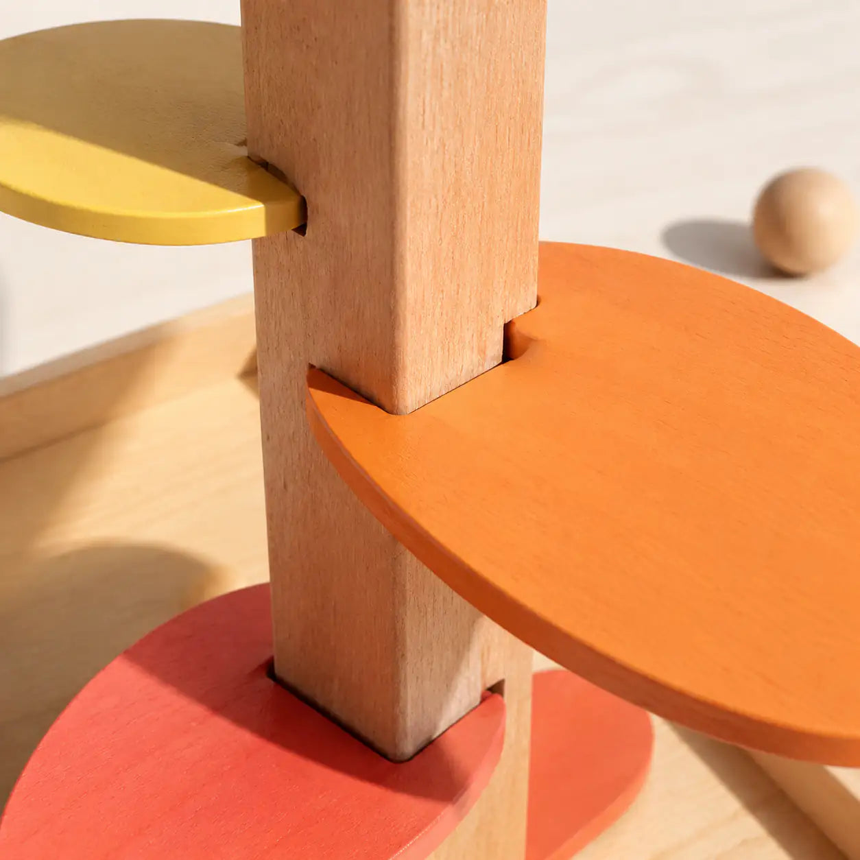 Close-up of the smooth sanded wood and rainbow leaf chimes on the marble run music tree
