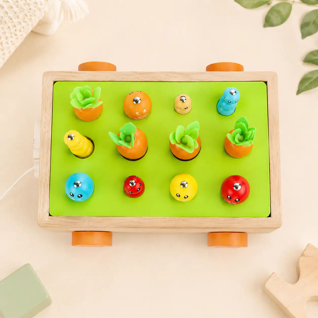 Magnetic fishing game on the Montessori harvest cart with wooden fish and caterpillars