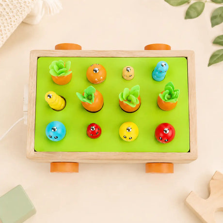 Magnetic fishing game on the Montessori harvest cart with wooden fish and caterpillars